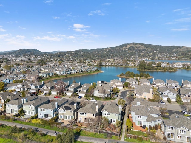 birds eye view of property with a water and mountain view