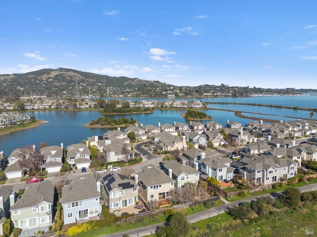 drone / aerial view with a water and mountain view