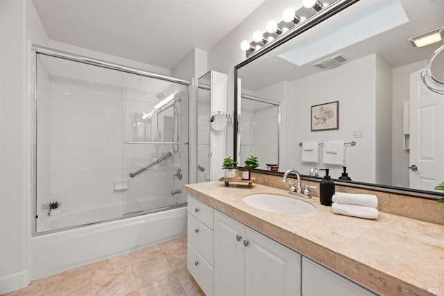 bathroom featuring enclosed tub / shower combo, vanity, and tile patterned flooring