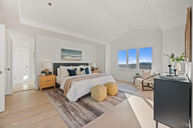 bedroom featuring vaulted ceiling and light wood-type flooring