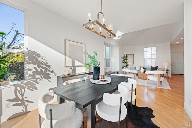 dining room with a notable chandelier and light wood-type flooring