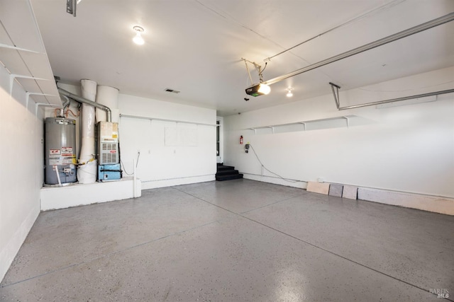 garage with heating unit, a garage door opener, and gas water heater