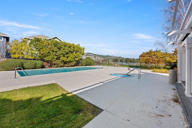 view of swimming pool featuring a patio and a mountain view