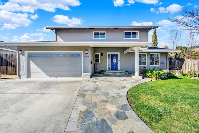 view of front of house featuring a garage and a front yard