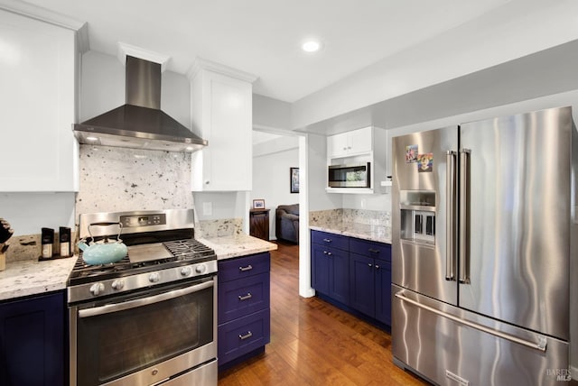 kitchen featuring extractor fan, white cabinetry, dark wood-type flooring, stainless steel appliances, and blue cabinetry