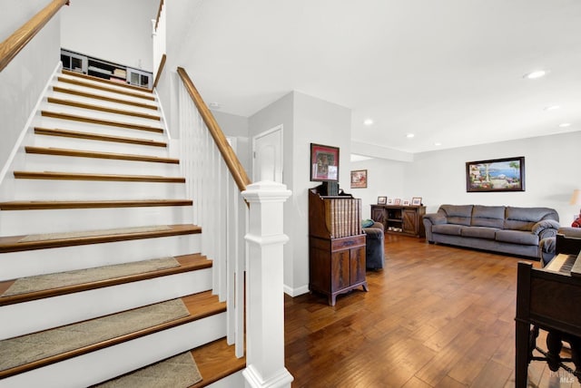 stairs featuring hardwood / wood-style floors