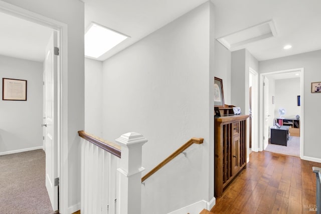 corridor with a skylight and hardwood / wood-style floors