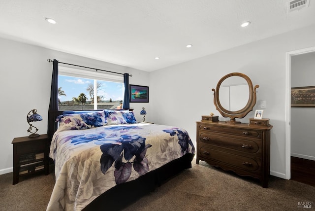 bedroom with dark colored carpet