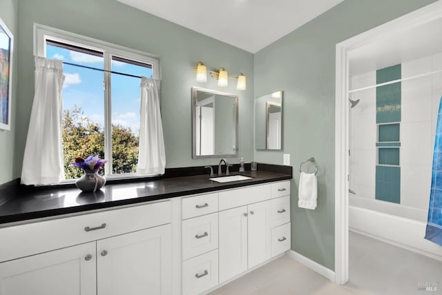 bathroom with shower / tub combo with curtain, vanity, and tile patterned floors