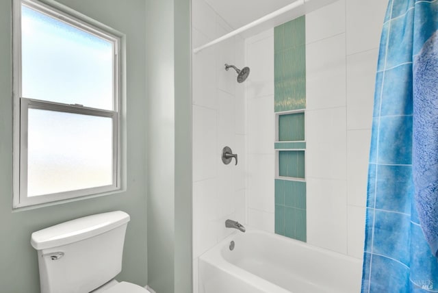 bathroom with shower / bath combo with shower curtain and toilet