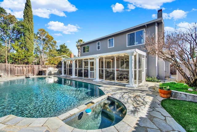 view of swimming pool with a patio area and a sunroom