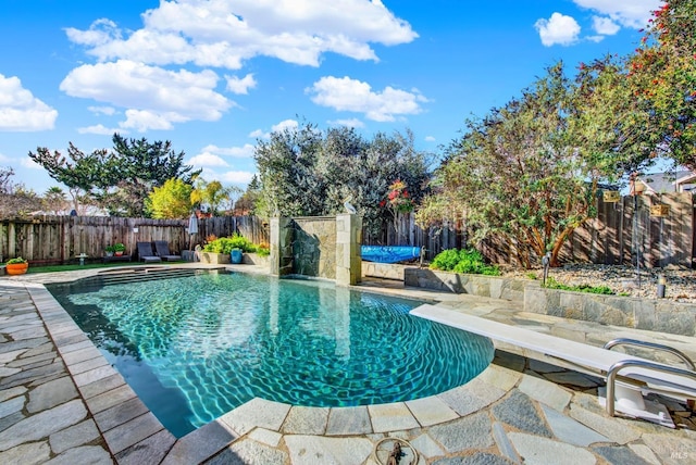 view of swimming pool with a diving board and a patio area