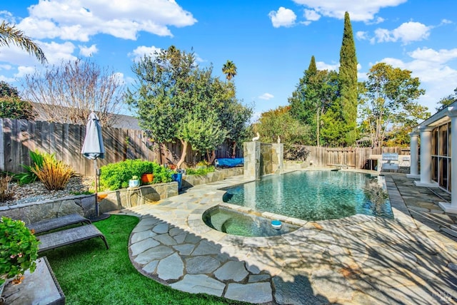 view of pool with an in ground hot tub and a patio