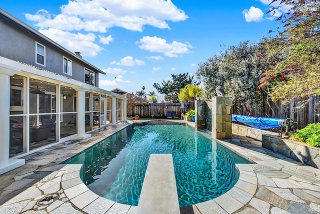 view of pool with a diving board and a patio area