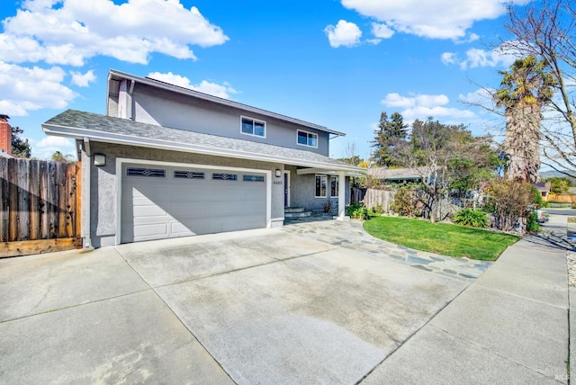 view of front of house featuring a garage and a front lawn