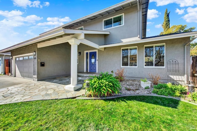 view of front of property with a garage and a front lawn