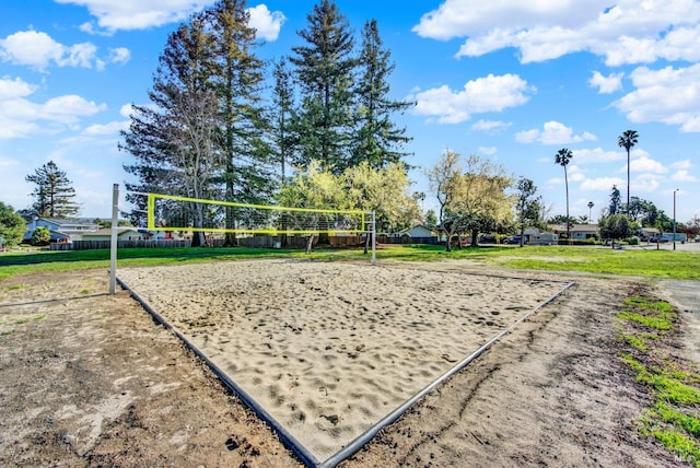 surrounding community featuring a yard and volleyball court