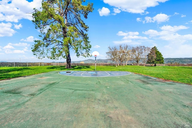 view of basketball court featuring a lawn