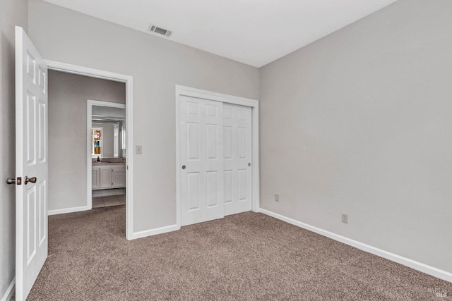 unfurnished bedroom with carpet and a closet