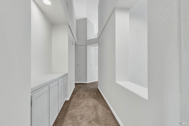 hallway featuring light colored carpet