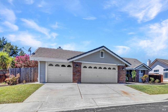 ranch-style home with a garage and a front yard