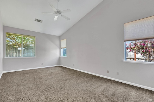 carpeted empty room with vaulted ceiling and ceiling fan