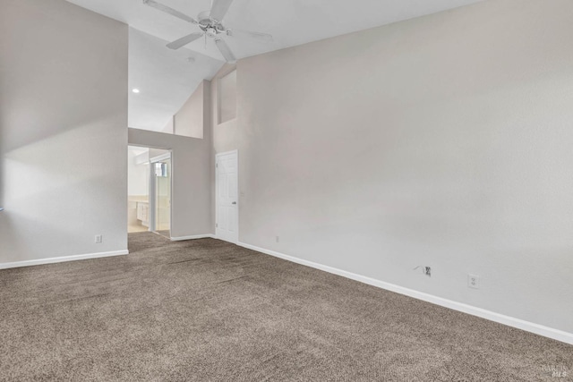 carpeted empty room with ceiling fan and high vaulted ceiling