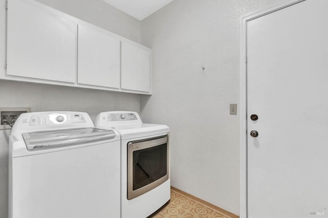 laundry area featuring cabinets and washer and clothes dryer