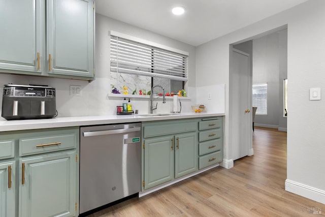 kitchen with dishwasher, sink, and light hardwood / wood-style flooring