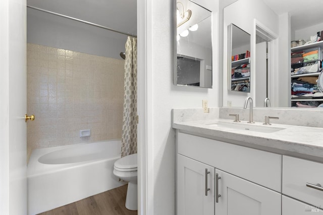 full bathroom featuring shower / tub combo, hardwood / wood-style floors, vanity, and toilet