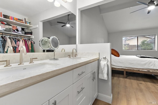 bathroom featuring vanity, hardwood / wood-style flooring, vaulted ceiling, and ceiling fan