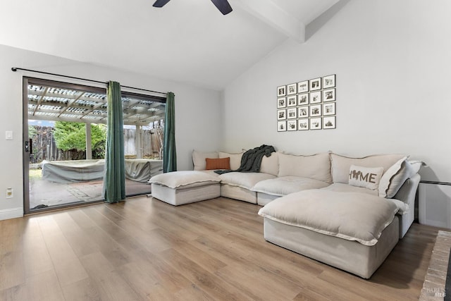 living room featuring ceiling fan, hardwood / wood-style floors, and vaulted ceiling with beams