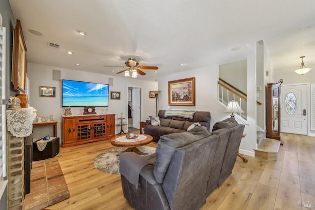 living room featuring ceiling fan and light wood-type flooring