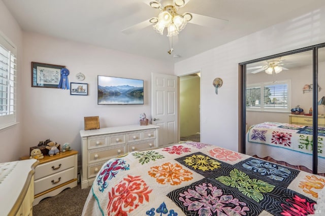 carpeted bedroom featuring multiple windows, a closet, and ceiling fan