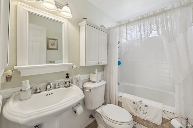 full bathroom with sink, shower / tub combo with curtain, and toilet