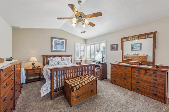 carpeted bedroom featuring ceiling fan, lofted ceiling, and a textured ceiling