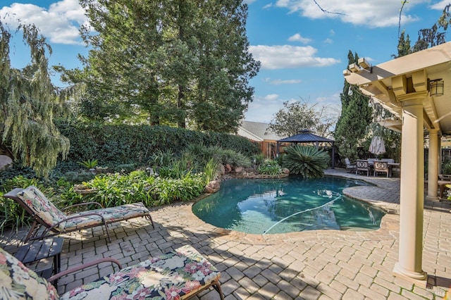 view of swimming pool featuring a gazebo and a patio area