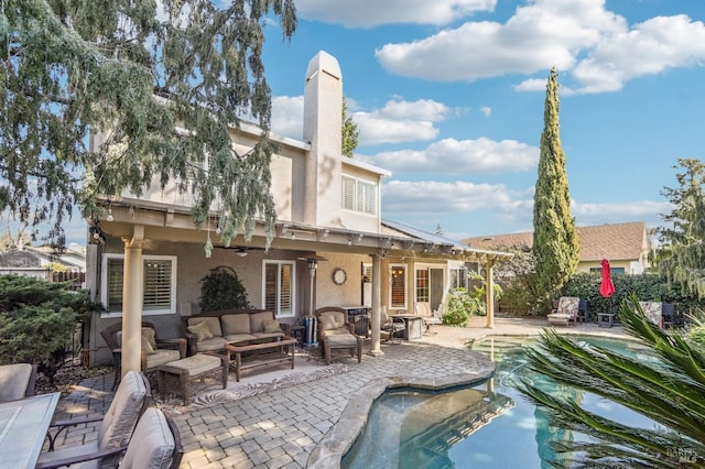 back of house with an outdoor living space, a patio, and ceiling fan