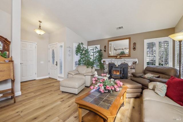 living room featuring lofted ceiling and light hardwood / wood-style flooring