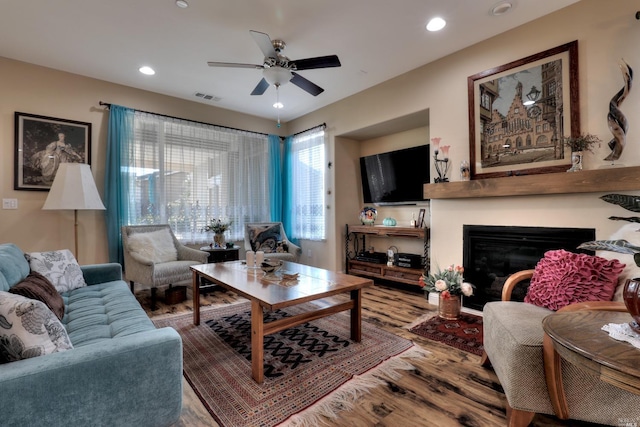 living room with wood-type flooring and ceiling fan