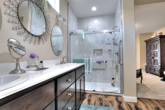 bathroom featuring a shower with door, vanity, and hardwood / wood-style floors