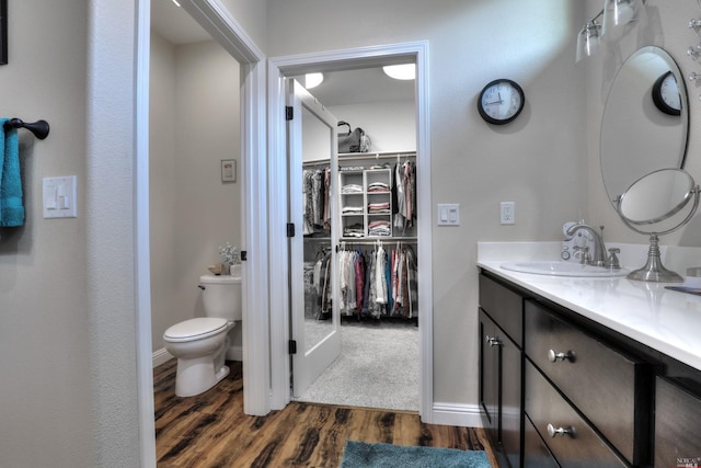 bathroom with vanity, hardwood / wood-style floors, and toilet