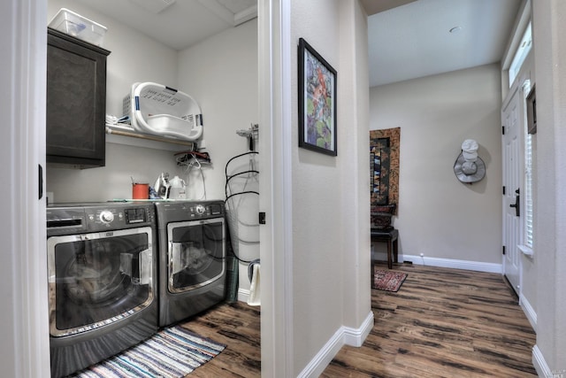 clothes washing area with dark hardwood / wood-style flooring, independent washer and dryer, and cabinets