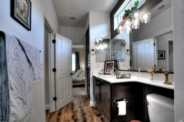 bathroom with vanity, hardwood / wood-style floors, and toilet