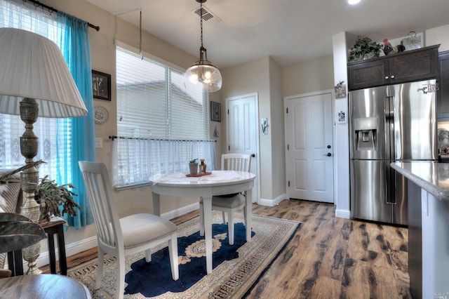 dining room featuring a wealth of natural light and light hardwood / wood-style floors