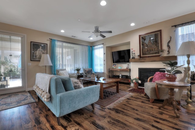 living room with ceiling fan and dark hardwood / wood-style flooring