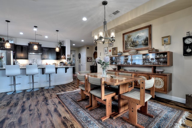 dining room with a notable chandelier and dark hardwood / wood-style flooring