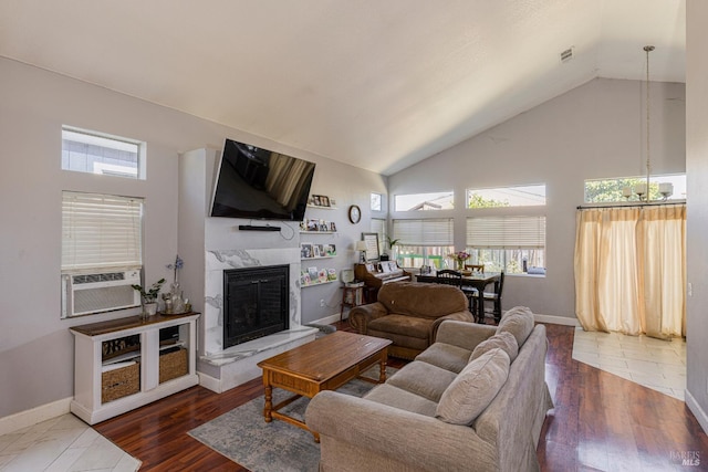 living room featuring high vaulted ceiling, a high end fireplace, cooling unit, and dark hardwood / wood-style flooring