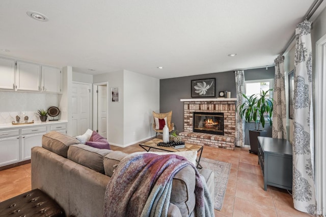 living area with recessed lighting, light tile patterned flooring, a fireplace, and baseboards