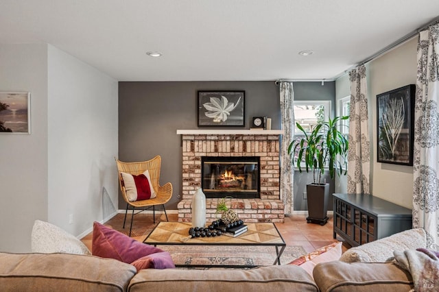 living area featuring baseboards, a fireplace, and tile patterned flooring